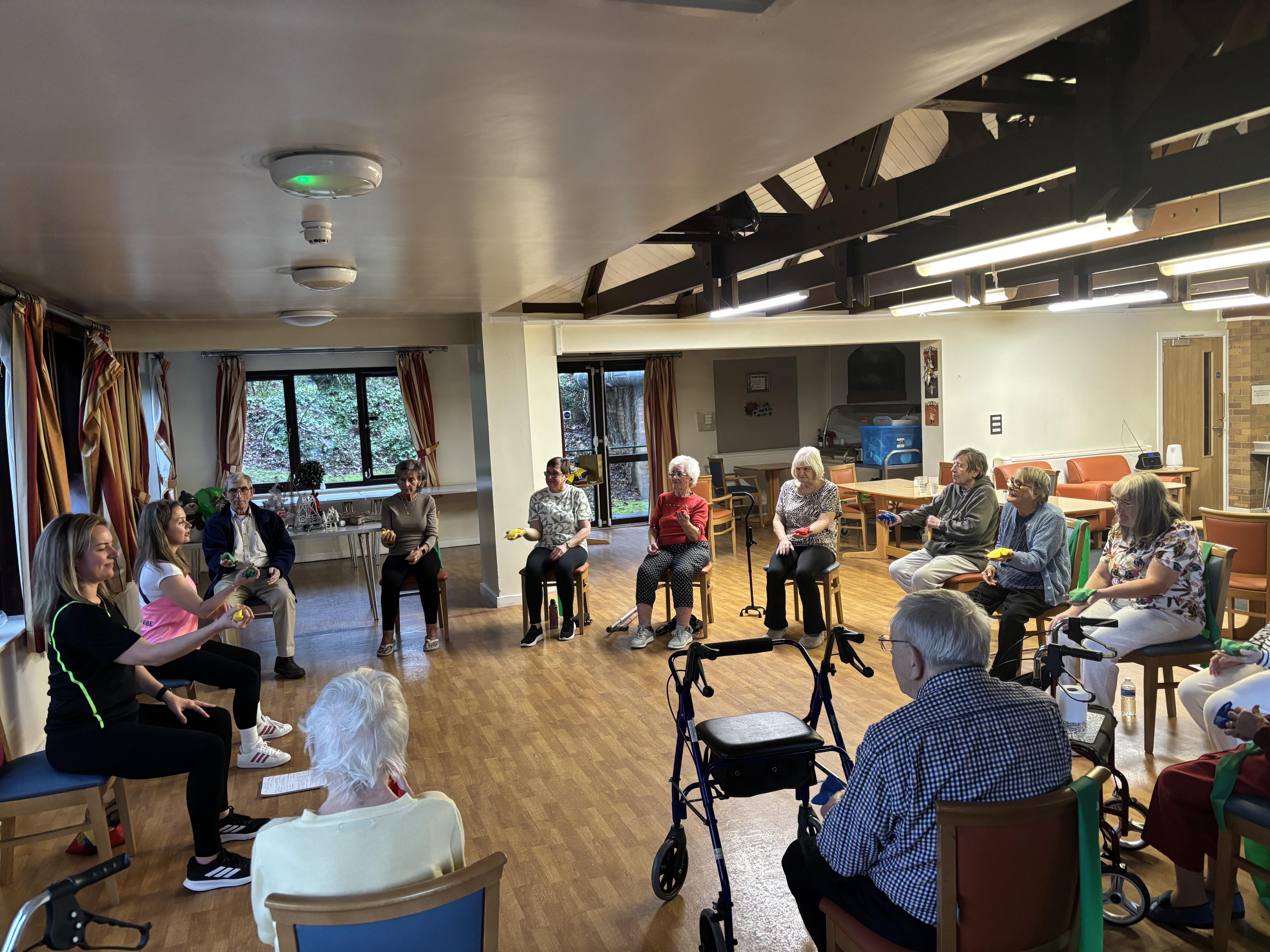 Older adults doing chair exercise class